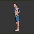 Shirtless Man With Blue Towel Over Shoulder And Blue Shorts Standing Barefoot On Gray Background