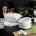 Modern White Kitchenware Display With Pots Bowls Copper Holders And Green Plants On Shelves