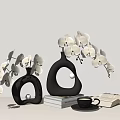 Modern Black Vases With White Orchid Flowers Stack Of Books Open Book And Coffee Cup