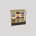 Various Decorated Cakes Displayed In Multi Shelf Glass Display Case