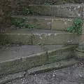 Ancient Stone Spiral Staircase With Mossy Steps Stone Walls And Green Plants