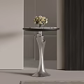 Modern Side Table with Round Tabletop Silver Base and Vase of White Flowers