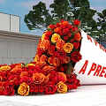 Scattered Red Yellow Roses With Tilted White Scroll Showing A Precious Gift Near Modern Building