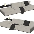 Beige Sectional Sofa Featuring Gray Pillow Blanket and Black Side Table with White Vase