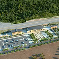 Aerial View of Modern Station With Spacious Parking Lot Lush Greenery and Surrounding Forest