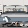 Modern Double Bed With Blue Upholstered Headboard And Decorative Pillows In Cozy Bedroom