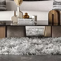 Modern Sofa And Coffee Table Set With White Upholstery Decorative Pillows And Soft Rug