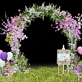Floral Event Entrance Arch With Pink Purple Flowers Balloons Easel Sign And Green Grass