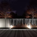 Serene Night Garden Landscape With Red Leaf Trees And Illuminated Waterfall Wall