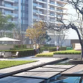 Modern High Rise Residential Building With Glass Curtain Walls Greenery And Outdoor Courtyard