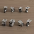 Set of Metal Casters with Various Designs Placed on Wooden Floor