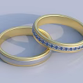 Two Elegant Gold Matching Rings With Blue Gemstones And Smooth Design
