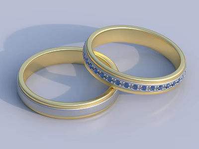 Two Elegant Gold Matching Rings With Blue Gemstones And Smooth Design 3d model