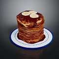 Stacked Pancakes Topped With Banana Slices And Chocolate Sauce On Blue White Plate