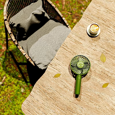 Outdoor Table with Wicker Chair Gray Cushion Small Green Fan and Coffee in Natural Setting 3d model