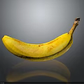 Fresh Yellow Banana with Brown Spots on Black Background and Clear Reflection