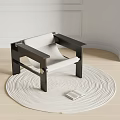 Minimalist Leisure Chair With Dark Frame Light Fabric On Round Woven Rug And Open Book