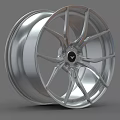 Stylish Silver Alloy Wheel Rim With Modern Spoke Design And Central Logo