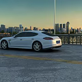 Urban Road Facilities Including Street Lamps Railings Yellow Lines And White Car At Sunset