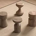 Four Wooden Stools with Various Designs in Indoor Setting on Beige Rug