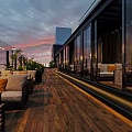 Rooftop Bar Outdoor Lounge With Sofa Table Wine Bread Umbrella And Evening View