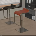 Modern Black and Orange Bar Stools with Metal Bases by Window and Bookshelf