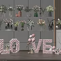 Decorative Floral Vases On Display Shelves With LOVE Letters And Balloons Decoration