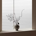 Textured Ceramic Vase With Twiggy Branches And Small Blooms On Window Sill By Blinds