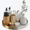Stylish Bathroom Accessories on Gold Tray with Wooden Holders Black Pump Bottles and Green Plant