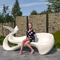 Unique Curved White Public Chair in Outdoor Space with Green Plants and Stone Wall