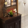 Black Entryway Side Cabinet with Drawers Doors Accent Chair Decorative Paintings Floor Lamps Green Plant