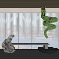 Modern Stone Sculpture With Twisted Green Plant Art And Water Basin In Interior Space