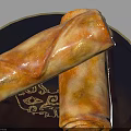 Crispy Fried Spring Rolls Placed on Blue Plate with Gold Rim and Patterns