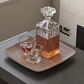 Stylish Wine Bottle And Glasses On Wooden Tray With Amber Liquid On Table
