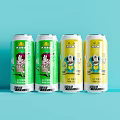 ALKA Beverage Four Cans With Green And Yellow Cartoon Characters On Light Blue Background