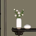White Striped Vase with Pink Flowers Green Leaves and Short Round Vase on Dark Table