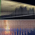 Modern Building Facade With Vertical Lines Greenery And Illuminated Glass Reflections