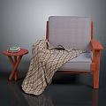 Gray Cushioned Chair With Wooden Armrests Plaid Blanket And Cross Legged Side Table With Books
