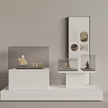 Museum Exhibition Display Featuring White Pedestals Glass Cases Small Sculptures And Information Panel