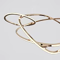 Contemporary Brass Chandelier With Intertwined Circular Metal Rings For Modern Interior