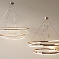 Two Modern Circular Chandeliers With Illuminated Rings And Metallic Frames