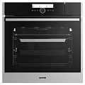 Modern Kitchen Appliances Including Stainless Steel Refrigerator And Built In Ovens With Range Hood
