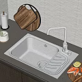 Stainless Steel Kitchen Sink on Dark Countertop with Modern Faucet Wooden Cutting Boards and Fresh Lemon Slices