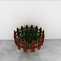 Green Grass Plants In Round Brown Wooden Fence Planter On Gray Floor With White Wall