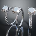 Three Elegant Silver Rings With Large Transparent Gemstones And Small Diamond Decorations