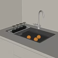 Stainless Steel Kitchen Sink With Running Water Faucet And Oranges On Countertop