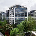 Modern Mid Rise Residential Apartment Buildings With Glass Facade Green Landscape And Trees