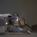 Damaged Intelligent Machine Lying on Sandy Ground With Broken Mechanical Parts and Metallic Body