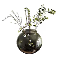 Round Glass Vase With Green Leaves And Small Branches Floral Arrangement