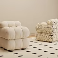Cream And Black Patterned Puffed Ottomans On Geometric Rug In Modern Interior